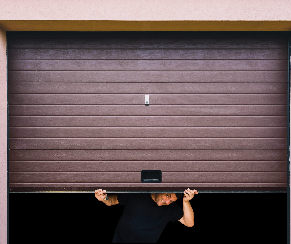 Homeowner manually opening a garage door using the emergency release cord.